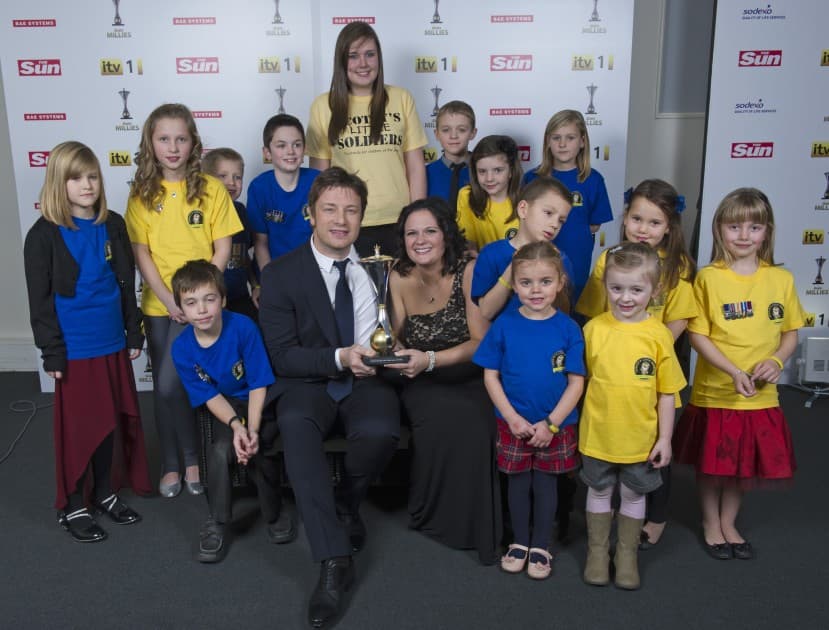Nikki receiving the Sun Military Award from Jamie Oliver, with Scotty's Little Soldiers